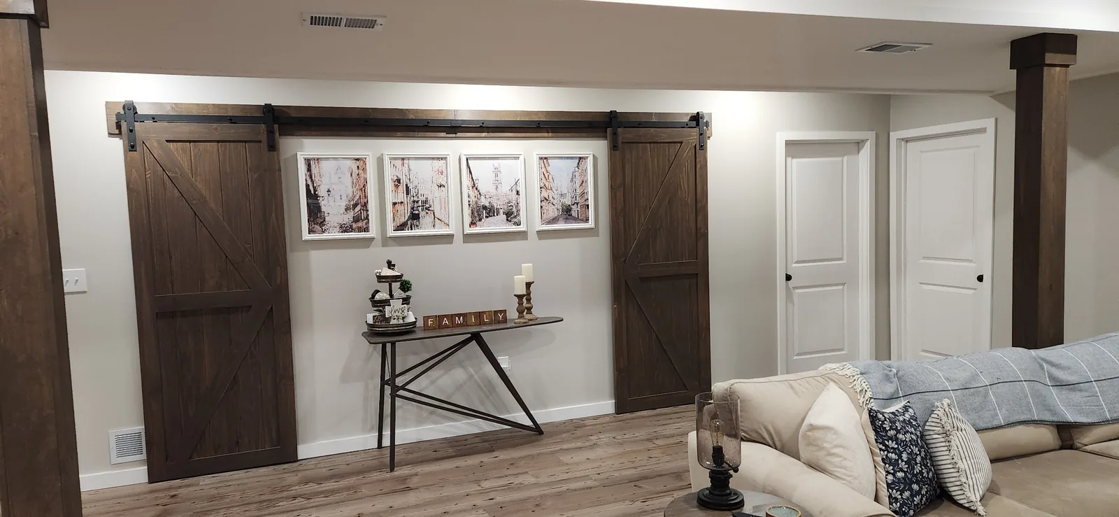 Finished basement with stained sliding barn doors and interior trim