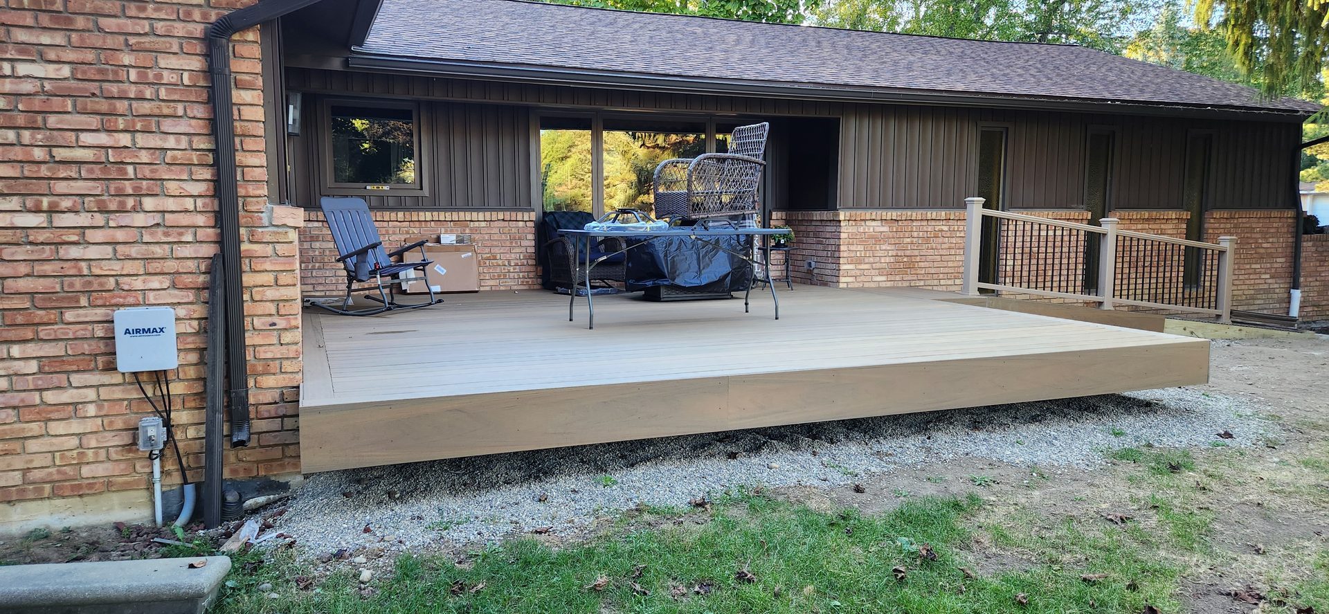 Low composite deck beside covered patio
