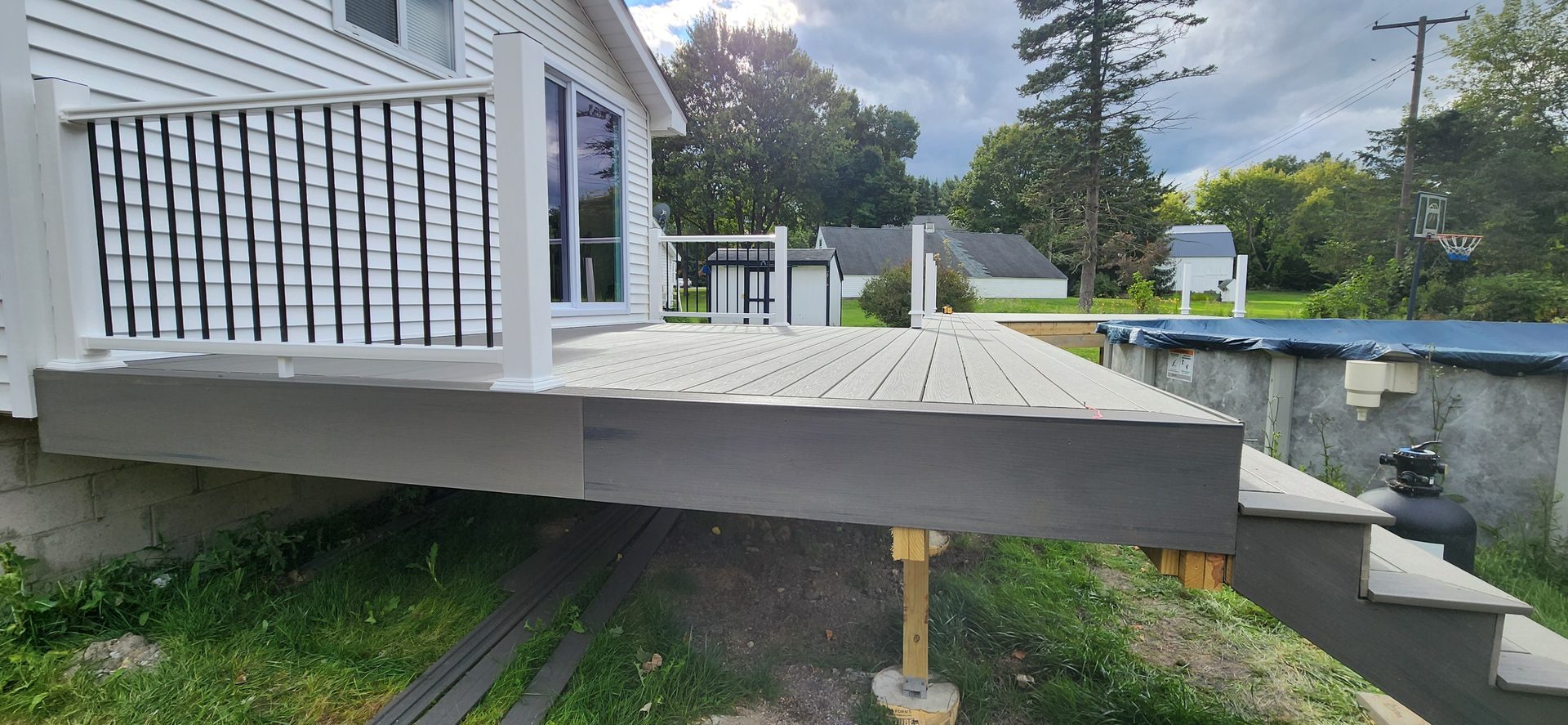 Deck repair project with white railing