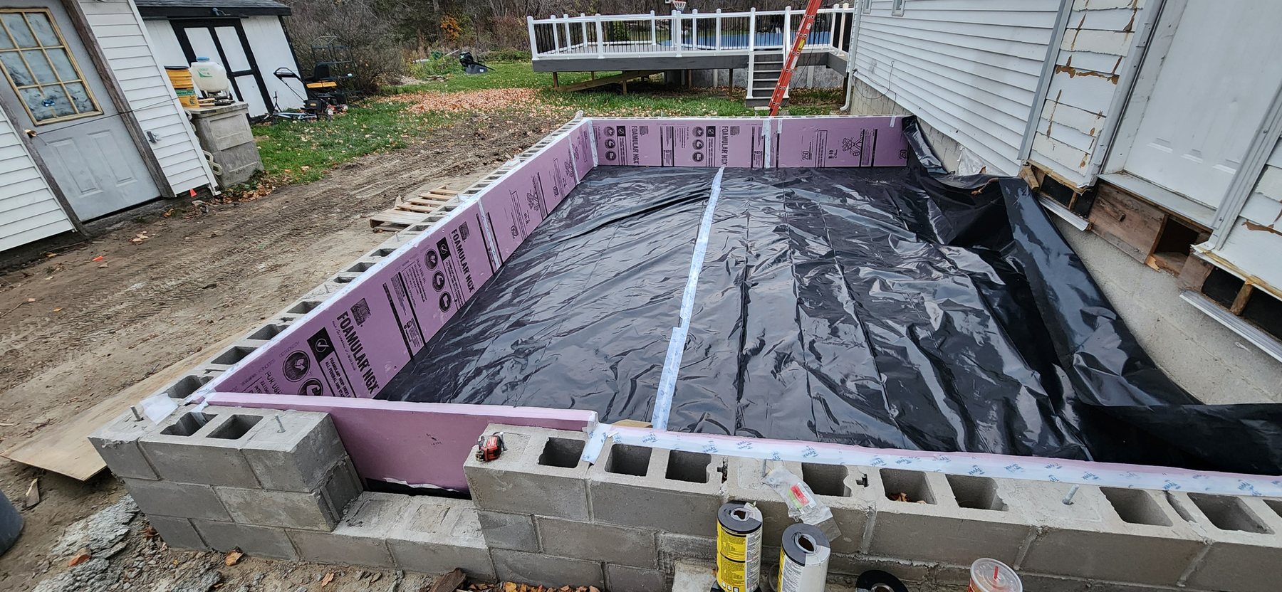 Foundation insulation and vapor barrier during Irwin addition construction