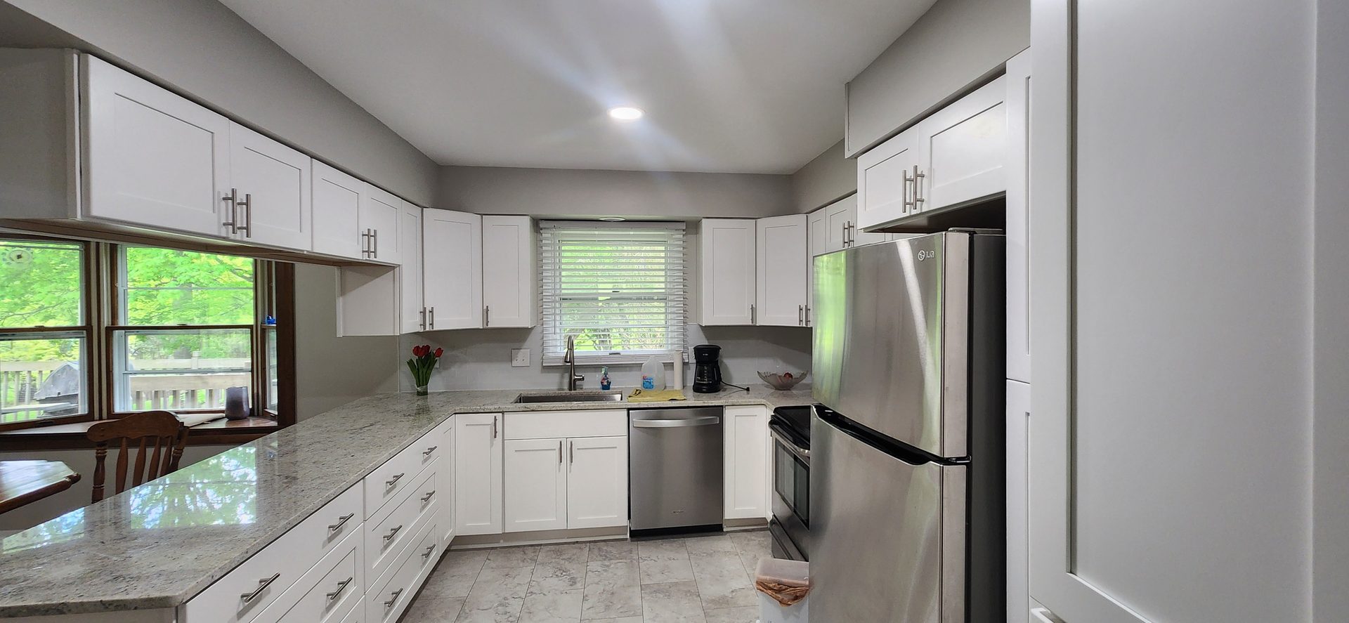 Bright kitchen remodel with white cabinetry and recessed lighting